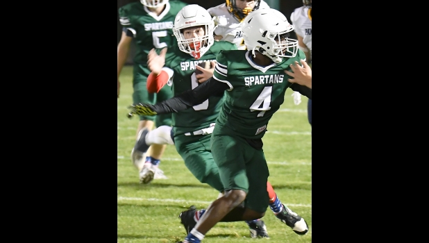 Carson Torrez (#0) cuts up the middle following #4 Ki’Jauhn Foor during Friday night’s Jack Pine Crossover game against the SSC Panthers.