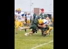 BROC BODRIE (#77) AND DAKOTA MAES (#2) wrap up the Harrison runner mid-way through the First Quarter of Friday’s 44-15 loss to the Hornets by the Spartans. --Journal Photo