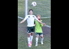 ALEX RIVARD (#10, right) heads the ball away from the Spartan goal as keeper Levi Ellison looks on during the second half of the District loss to Roscommon last week.