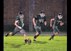 ANTHONY CHARBONNEAU (#8) kicks off for Friday night’s game against Shepherd as the persistent rain falls. 				 --Journal Photo