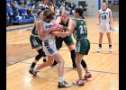 BRIELLE HERNER (#10), SUMMER POMAVILLE (#20), AND JASMINE BRAZEAU (#25) all fight the Gladwin player for a rebound in Thursday’s game. The Lady Spartans led most of the game, but lost in overtime. --Journal Photo