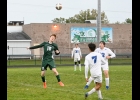 BERKLEY ROOKER (#10, left) heads the ball early in the Spartans 8-0 loss to Gladwin in the MHSAA District semi-final. --Journal Photo