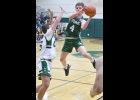BRADEN SLOWINSKI (#4, right) avoids the Clare defender to take a shot in Friday’s loss to the Pioneers. --Journal Photo
