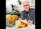 BRIAN SAHA IS pictured with their Famous Stuffed Pizzaloaf. --Courtesy Photo