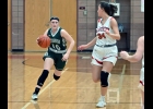 BRIELLE HERNER (#10) drives up the court during Thursday’s Game at Beaverton. Herner led the team with 20 points in the effort. --Journal Photo
