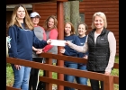 IDEPENDENT BANK-PINCONNING EMPLOYEES spent part of their Columbus Day volunteering at Camp Fish Tales, helping with fall clean-up. Manager Tricia Foldie (left) presented Camp Director Shannon Forshee (right) with a check for $500, made up of employee donations throughout the year and matched by the Bank. Employees volunteering, besides Foldie, were (from left): Lorcie Ford, Stacie Sturm, Tracey Bejcek, and Kayla Apley. --Journal Photo
