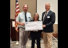 Roberta Spencer, President of the Noon Optimist Club, presents a mock check to John Sanford (left) Central Elementary Principal and Michael Vieau, PHS Superintendent. --Courtesy Photo
