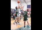 CARSON PARKS (#12) avoids a block and shoots for 2 points against Clare on Friday night. Parks also hauled in 3 rebounds against the Pioneers. --Journal Photo