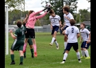 CARTER COUTCHER (#1) robs the Shepherd player of a header on a corner kick in the Spartans 0-7 loss on Monday afternoon. Coutcher made 21 saves in the effort. --Journal Photo
