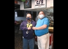 STANDISH-STERLING CENTRAL High School Principal Gary Roper accepts a stack of gift cards from CJ’s Sports Grill owner Clif Holland. After seeing last week’s news about a donation from a PHS Alumnus for deserving families, an SSC Grad followed suit, providing 18 gift cards to Standish-Sterling area families and another 7 for Pinconning Area families. The Christmas Spirit of helping deserving neighbors is alive and well in Northern Bay and Arenac Counties. --Journal Photo