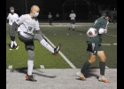 CLINT KANTHE (#14) sends the ball past the Clare defender in the Spartans loss to the Pioneers in the second OT of Thursdays MHSAA District 45 Quarterfinal. --Journal Photo by Colleen Dybas