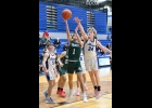 COLE BRADY (#1) fights his way inside to throw up this shot against Gladwin on Friday. --Journal Photo