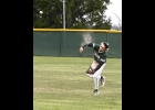 DAKOTA MAES throw to home from short right field is so hard that the dust from his uniform billows in the wind. The throw was accurate but a second too late and the Bay City Central runner scored. --Journal Photo
