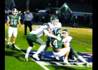 ARTHUR DENNISON (#88) wraps up the Clare runner and Dakota Maes (#2) and Jack Boettcher (#10) come in to assist, early in the Spartans Friday road loss to the Pioneers, by a score of 42-0. --Journal Photo