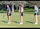 MEMBERS OF THE GIRLS GOLF TEAM practice on the putting green earlier this year. --Courtesy Photo
