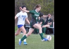 LEXI DROUSE (#4, right) controls the ball against the Oscoda Owls in last week’s game. 		     --Journal Photo