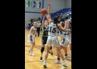 MACKENZIE EILF (#12) gets a shot off against Gladwin on Friday. She scored 2 points in the game. 					           --Journal Photo