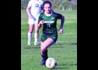 MADDY GRZEGORCZYK (#3) chases down a Gladwin shot to clear it to the side last Tuesday.