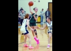MAGGIE HISTED (#3) makes a hard cross-court pass in Friday’s loss to Meridian.