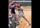 RILEY HILL (#22) battles his way to the basket against Gladwin on Friday. --Journal Photo
