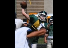 THE SPARTANS take to the air during their scrimmage against Cass City Last Thursday. --Journal Photo
