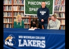 PHS SENIOR LAUREN LAURES signs a National Letter of Intent to continue her basketball career as a member of the Mid-Michigan College Lakers as (l-r) PHS Coach Mindy Laures, Lakers Coach Matt Rodenbo, and PHS Assistant Coach Bill Laures look on. --Journal Photo