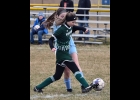 TESS GASICIEL (#19) works past the Garber player in Saturday’s frigid Bay County Tournament match. She scored the Spartans only goal in the game, and again in Monday’s 1-1 tie with Oscoda.	           --Journal Photo