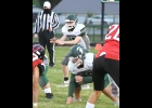 THADDEUS NASHATKA (#12) prepares for the snap in Friday’s loss to Beaverton. Nashatka, a freshman, went 11-for-12 passing for 59 yards in his first start for the Spartans. --Journal Photo