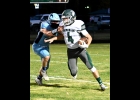 TOMMY YANOSKI (#4) pushes past the defender to gain a few more of his 75 rushing yards in Friday’s game against the Meridian Mustangs. The Spartans fell 6-35. --Journal Photo
