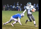 TOMMY YANOSKI (#4) avoids the first defender on one of his 14 rushes in Friday’s road loss to Gladwin. --Journal Photo