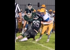 TYLER BROOKS (#36) grabs the Hornet’s ball-carrier behind the line in Friday’s Homecoming loss to Harrison. --Journal Photo